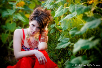 Portrait of a woman amongst sunflowers.