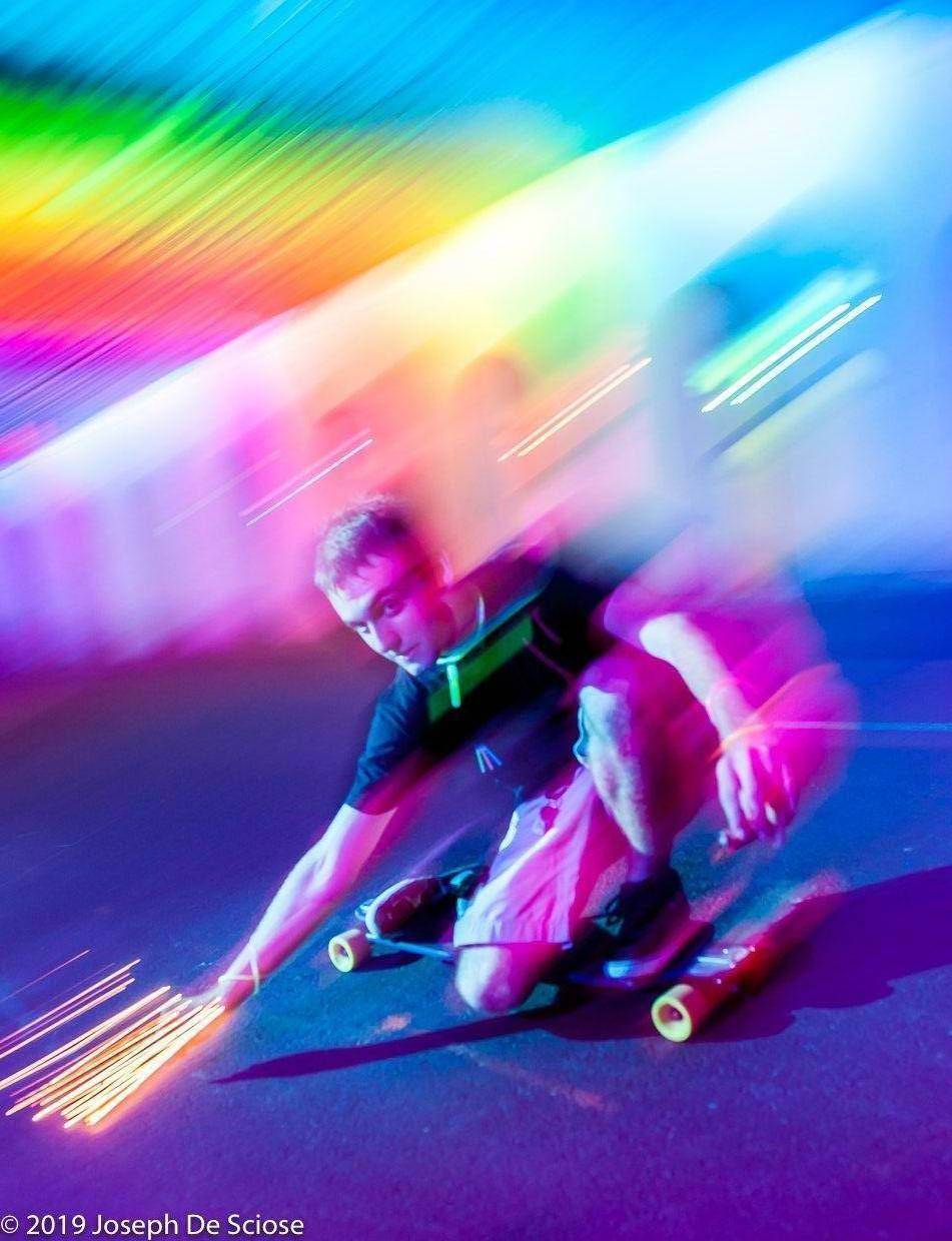 Rollerboarding through a lighted traffic tunnel.