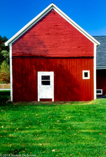 Red barn with green grass, blue sky, Vermont