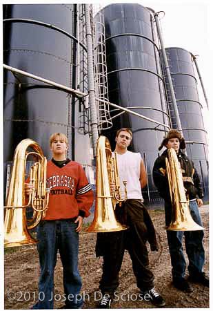 Atlantic, Iowa High School Tuba players in front of 3 corn silos